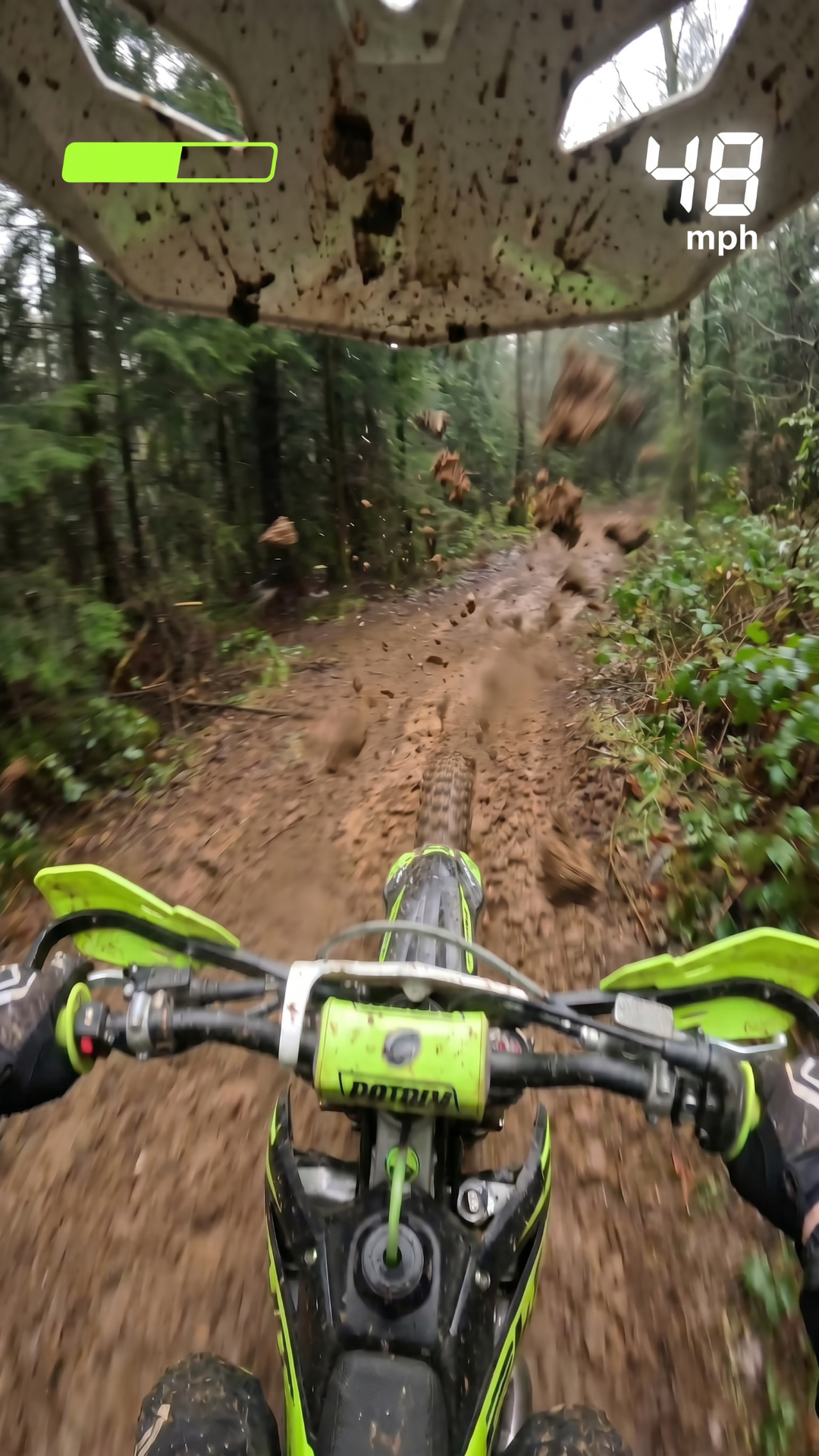 pov view of guy on a dirt bike Moving at high speed in in a muddy forrest he has to dodge the trees he should go through 3 sets of tree hurdles then add one fail scene and oone completion scene where he goes up a muddy ramp then soars in the air in victory